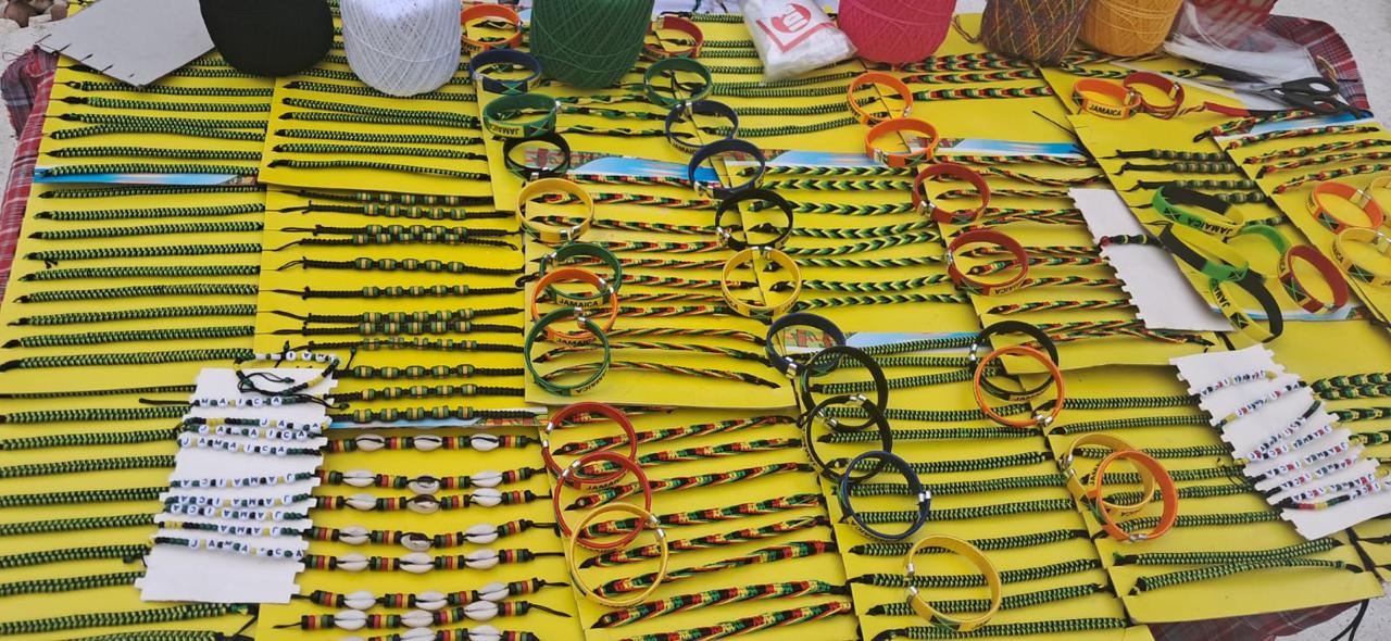 Colourful Jamaican bracelets and jewellery laid out on a market stall