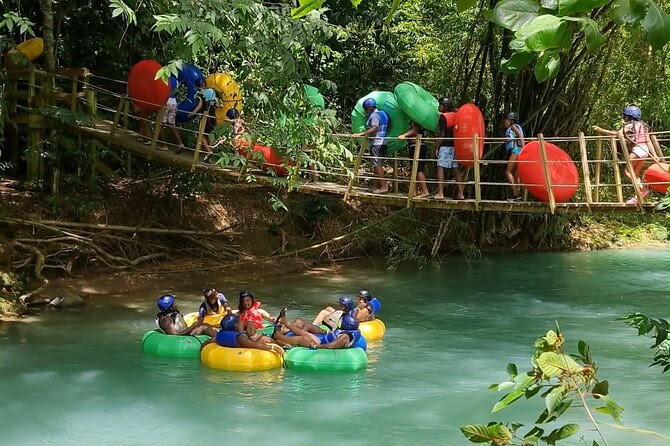 Travellers river tubing down a jungle river in Jamaica